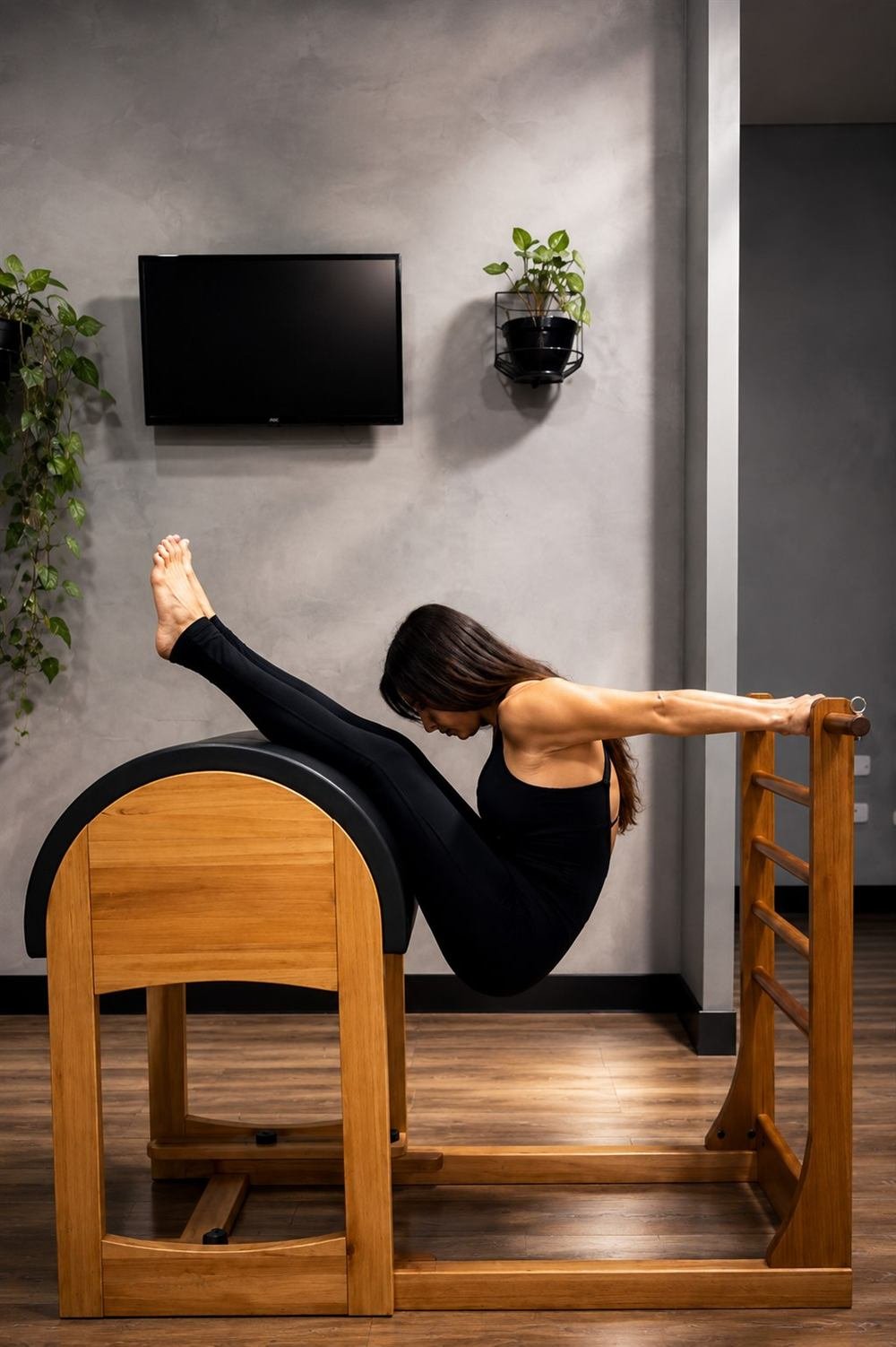 Aluna em exercício na escada (ladder barrel) do Pilates